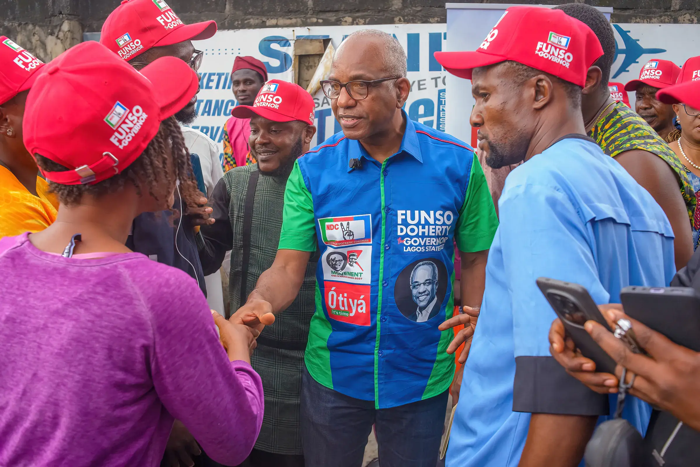 Funso Doherty with people during his visit to Alimosho.