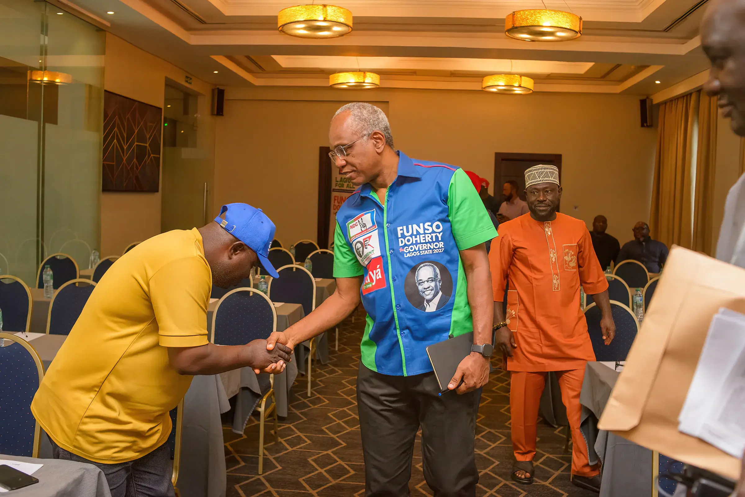 Funso Doherty with people at a meeting with NDC candidates.